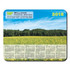 A counter mat featuring a scenic field of yellow flowers with a calendar for the year 2016 at the bottom. It has a logo.