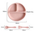 A silicone kids suction plate in soft pink with three compartments, accompanied by a matching spoon and fork.