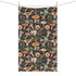 A tea towel featuring a vibrant mushroom and floral pattern with a dark background and natural colours.