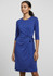 A blue women's dress features three-quarter sleeves and a tied waist detail, set against a neutral background. It has branding.