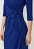 A blue dress featuring a tied detail at the waist and three-quarter sleeves. The dress has a smooth, elegant look.