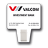 A white clip with a logo, featuring a sign that states "Valcom Investment Bank" and contact details.