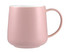 A pink ceramic coffee mug with a smooth finish and a curved handle. It features a white interior and has one logo.