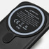 A black wireless charging power bank with a circular charging pad and a logo on the surface.