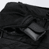 A black backpack featuring multiple zippered compartments, with one compartment containing a rolled-up item.