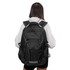 A black Eiger Backpack is being worn, featuring multiple compartments and a shoulder strap design.