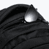 A black backpack featuring multiple zippered pockets and a pair of black sunglasses resting in one of the pockets.