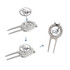 A silver golfers divot tool with a detachable ball marker, featuring a logo and intricate detailing.