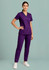 A woman wearing a purple scrub top and matching pants, standing confidently against a light background.