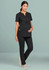 A black women's scrub top with a buttoned neck design, worn by a pregnant model, paired with black pants.