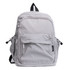 A grey backpack with multiple zippered compartments and side pockets, featuring a logo.