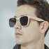 Wheat straw sunglasses in a light colour with dark lenses, showcased on a model's face.