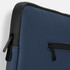 A navy blue soft-touch laptop sleeve with a black zipper detail and a logo on the front.