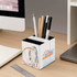 A three-panel foldable pen holder in white, featuring a colourful amusement park design, storing various pens and pencils.