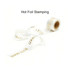 A roll of transparent ribbon with a gold hot foil stamped message reading "GOOD LUCK."