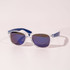 Clear sunglasses with blue arms and gradient lenses, resting on a pale background. The sunglasses feature a logo.