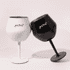 Two detachable wine glasses in black and white, featuring a logo on each, positioned together.