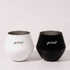 Two wine glasses, one white and one black, both featuring a logo, made for versatile use.