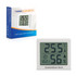 A digital temperature and humidity thermometer in white, displaying measurements, with a packaging box in the background.