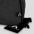 A black toiletry bag featuring a logo, with a smooth fabric texture and a zippered opening.