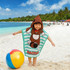 A kids' hooded change towel in teal with a raccoon design, featuring stripes and a beach ball on a sandy shore.
