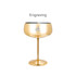 A stainless steel cocktail coupe in a shiny gold finish, featuring a logo on the side.
