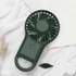 A portable pocket fan in dark green with a handle, featuring a circular fan design.
