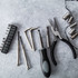 A 22-piece tool set featuring various metal tools, screwdrivers, pliers, and socket pieces in a sleek carry case.