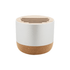 A round wireless speaker with a white top and a natural cork base, featuring slits on the top for sound.
