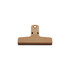 A tan plastic magnetic clip with a large flat surface and a hanging hole for easy storage.