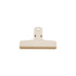 A beige plastic magnetic clip with a flat surface and a hanging hole at the top, featuring a small logo.