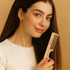 A wide-tooth beech wood comb held by a smiling woman, featuring natural wood colour and a simple design.