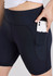 A pair of women's black bike shorts featuring a side pocket for a phone. The shorts have a high waistband for comfort.