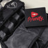 A black tech kit with compartments, featuring a wallet that has a logo and other tech accessories inside.
