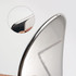 A stainless steel Gua Sha massage tool with a shiny, smooth surface and a curved edge, featuring a close-up detail.