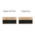 A wooden chalkboard name badge with a black writing surface and engraved sections, featuring a logo on one side.