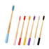 A set of large conical handle colourful toothbrushes in various hues, including pink, yellow, purple, and black, with a branding logo.