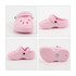 A pink paw-shaped clog shoe fridge magnet with ventilation holes and a strap, featuring a textured sole.