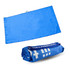 A blue suede fabric sand-free beach towel, displayed laid out flat and rolled up. The product has a branding logo.