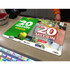 A colourful promotional counter mat featuring vibrant graphics and a logo, suitable for retail displays.