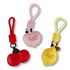Three bag charms in red, pink, and yellow, featuring apple and lemon shapes with one charm having a logo.
