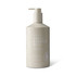 A hand and body wash in a beige pump bottle with a logo, featuring sea salt and pearl extract.