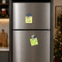 A silver fridge with two snow globe fridge magnets attached, featuring festive designs and bright colours.