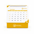 A desk calendar with a yellow base and a white top, featuring a month grid for December and a logo.