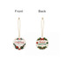 A ceramic ornament featuring a festive design of Christmas greetings in red and green on both sides. It has a gold string for hanging.