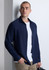 A navy long sleeve shirt with a button-up front, worn over a white t-shirt, paired with beige trousers.