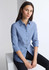 A women's long sleeve shirt in blue and white stripes, featuring a collar and rolled sleeves. It has a brand logo.