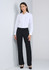 A long sleeve white shirt worn with black trousers, featuring a sleek design and a simple collar. It includes a logo.