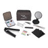 A grey travel pouch with a mirror, comb, tweezers, needles, thread, buttons, hair pins, and cloths.