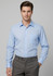 A light blue long sleeve button-up shirt with a chest pocket, paired with grey trousers. The model is standing neutrally.